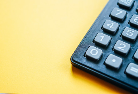 a calculator on a yellow background