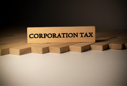 a wood block with the words corporation tax